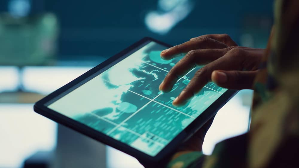 Hands using a tablet with an Ai map interface